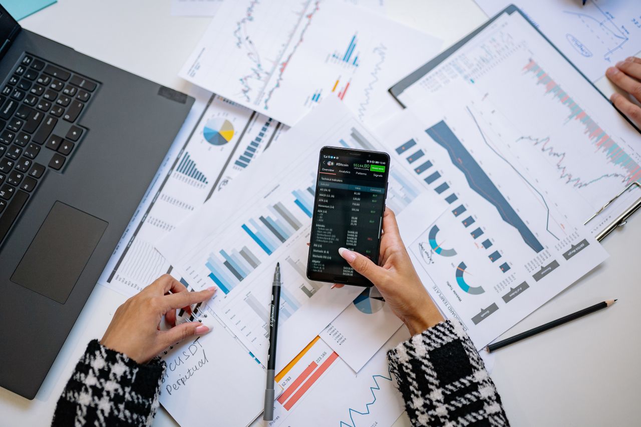 features-03 A top view on charts and smartphone in an office, showcasing data analytics.